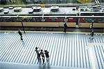 People standing on train platform, waving, high angle view