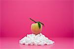 Food concept, fresh peach on top of pile of sugarcubes