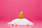 Food concept, potato on top of pile of sugar cubes