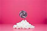 Food concept, lollipop sticking out from pile of sugar cubes