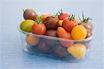 Assorted cherry and plum tomatoes in plastic container