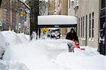 A man using a snow blower on Park Avenue after a blizzard in New York City, New York State, United States of America, North America