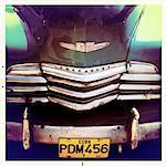 Detail of the front of an old green Chevrelet showing the chrome grill and numberplate, Vinales, Cuba, West Indies, Central America