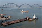 Boat activity on the Irrawady River with Yadanabon bridge, Sagaing, Myanmar, Asia