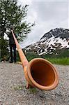 Man playing alpenhorn or alpine horn, Switzerland, Europe