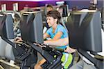 Woman using Exercise Equipment in Gym