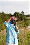 Man Taking Picture with Vintage Camera, Ontario, Canada