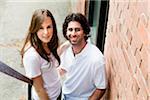 Close-up Portrait of Young Couple Standing on Fire Escape