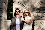 Portrait of Young Couple Standing in front of Stone Sculptures in Park, Ontario, Canada