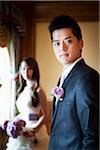 Portrait of Groom with Bride in Background