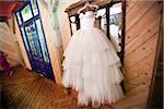 Wedding Gown Hanging in front of Mirror