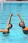 Swimmers Performing in Swimming Pool, Synchronized Swimming