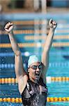 Young Woman Celebrating Success in Swimming Pool