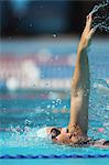 Young Woman Swimming in Pool