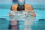 Young Man Swimming Breaststroke