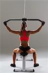 Female weightlifter using weight machine