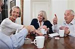 Senior friends playing cards