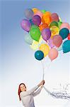 Young woman outdoors with balloons