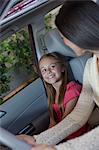 Daughter sitting in car with her mother