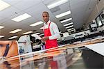 Manual worker looking down at prints