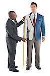 Man getting measured by a tailor on a white background