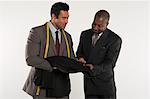 Tailor showing man a black suit