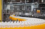 Orange juice bottles on production line