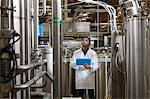 Factory worker inspecting bottling factory