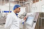 Industrial worker at bottling machine