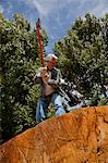 Low angle view of man about to chop wood