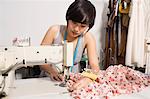 Fashion designer sewing fabric