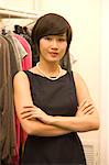 Portrait of confident Asian fashion designer standing with arms crossed
