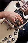 Gros plan de la main de l'homme joue de la guitare électrique