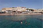 Swimmers enjoy the clear Red Sea waters at Sharks Bay, Sharm el-Sheikh, Sinai South, Egypt, North Africa, Africa