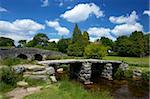 Medieval clapper bridge made of four massive granite slabs crossing the East Dart River, constructed in the 13th and 14th centuries, Postbridge, Dartmoor, Devon, England, United Kingdom, Europe