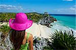 Tourist on the Caribbean coast looking over Tulum Beach to the ancient Mayan site of Tulum, Tulum, Quintana Roo, Mexico, North America