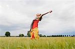 Femme souriante debout dans les hautes herbes