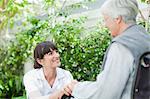 Nurse talking to older patient outdoors