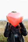 Girl holding heart-shaped balloon