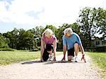 Older couple crouched in start position