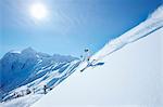 Skier coasting down snowy slope