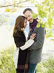 Portrait of young couple embracing under tree