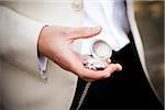 Groom Holding Pocket Watch