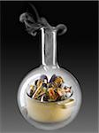 Casserole dish of mussels in a glass chemical testing bottle