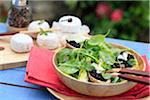 Baby spinach salad with tapenade on small toasts