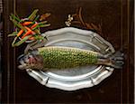 Salmon with zucchini scales on a silver platter