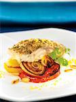 Oven-baked seabream coated in breadcrumbs,pan-fried tomatoes and onions