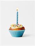 Cupcake with one blue birthday candle