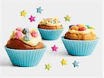 Assorted cupcakes in blue paper cups