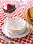 Camembert, bread and a glass of red wine